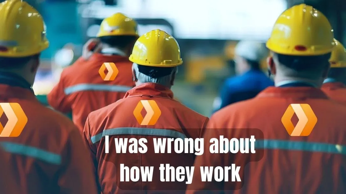 Workers in reflective vests and yellow hard hats with Cloudflare logos, captioned 'I was wrong about how they work' - representing misconceptions about Cloudflare Workers.